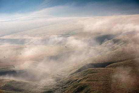 The fog on the plain alternates suggestive views in a slow decline, Castelluccio di Norcia, Sibillini National Park, Italy, Europe The fog on the plain alternates suggestive views in a slow decline, Castelluccio di Norcia, Sibillini National Park, Italy, Europe