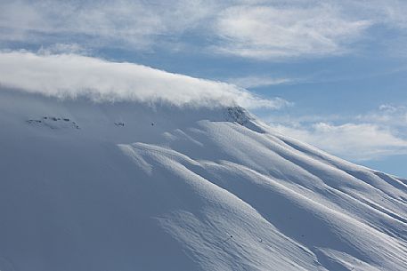 The Vettore mount with a hat of clouds in a beautiful winter day, Castelluccio, Sibillini National Park, Umbria, Italy, Europe