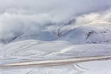 The snow covers the cultivated fields in Castelluccio di Norcia, Sibillini national park, Umbria, Italy, Europe