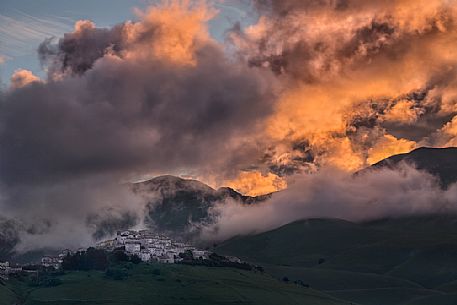 A dawn of fire over the village of Castelluccio di Norcia, Sibillini national park, Umbria, Italy, Europe