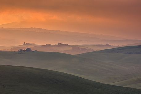 The beauty of the hills in Val d'Orcia at sunset, ridges and farmhouses typical of Tuscan beauties, Orcia valley, Tuscany, Italy The beauty of the hills in Val d'Orcia at sunset, ridges and farmhouses typical of Tuscan beauties, Orcia valley, Tuscany, Italy