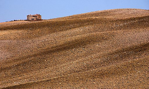 Farm adn plowed fields in the hills of the Val d'Orcia, Tuscany, Italy, Europe