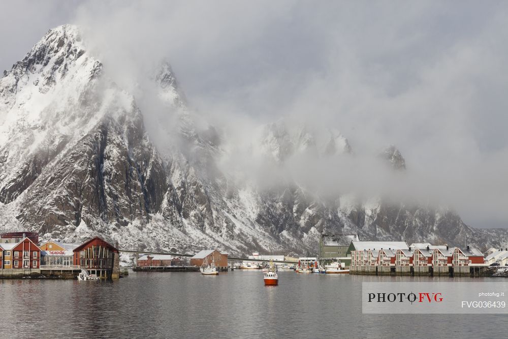 Fishing boat come back to the harbour of Svolvaer village, Lofoten island, Norway, Europe