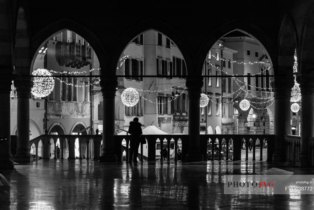 Woman in silhouette in the Loggia del Lionello towards Mercatovecchiohe at Christmas time, Udine, Friuli Venezia Giulia, Italy, Europe