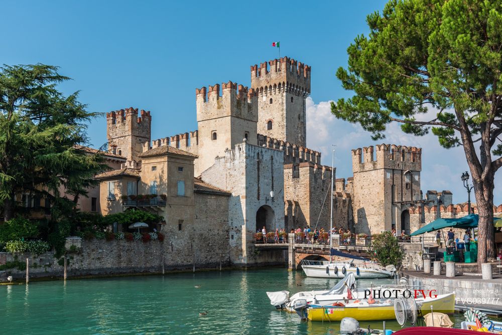 Tourists visiting the historic Scaliger Castle of Sirmione, Garda lake, Brescia, Lombardy, Italy