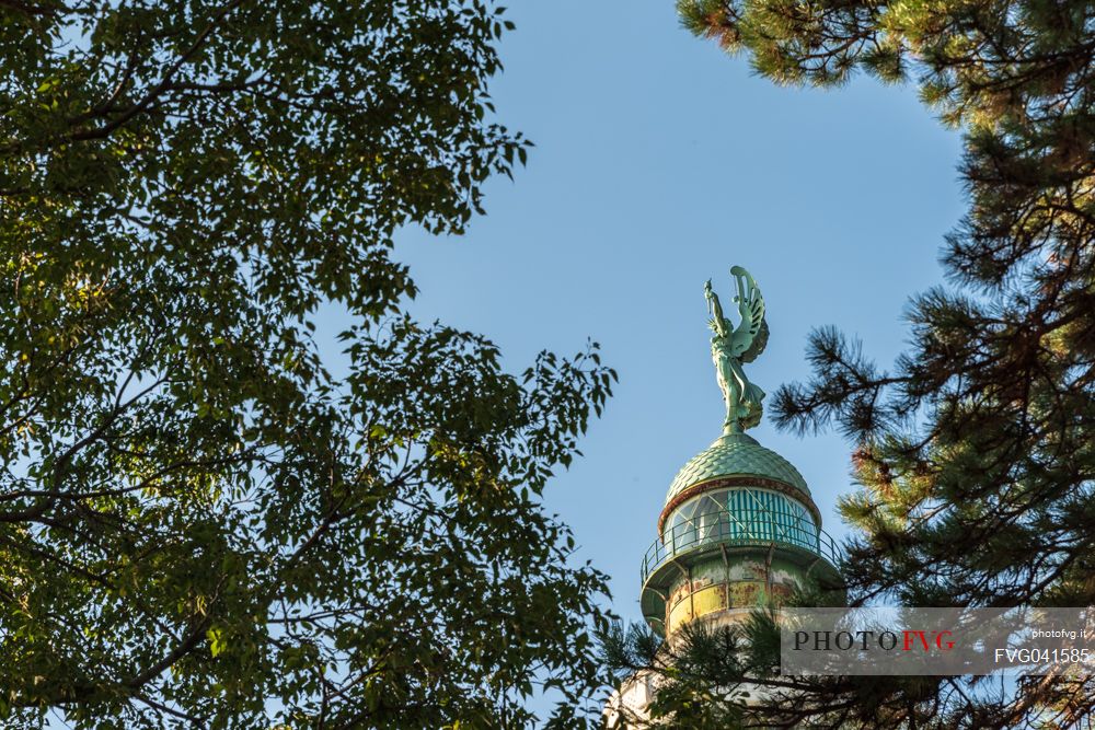 Vision among the trees, lighthouse of Victory, or Faro della Vittoria, National Monument in  Trieste, Friuli Venezia Giulia, Italy, Europe