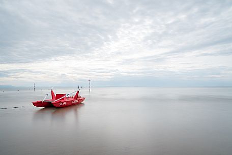 Red rescue boat moored in the Adriatic coast, Friuli Venezia Giulia, Italy, Europe Red rescue boat moored in the Adriatic coast, Friuli Venezia Giulia, Italy, Europe
