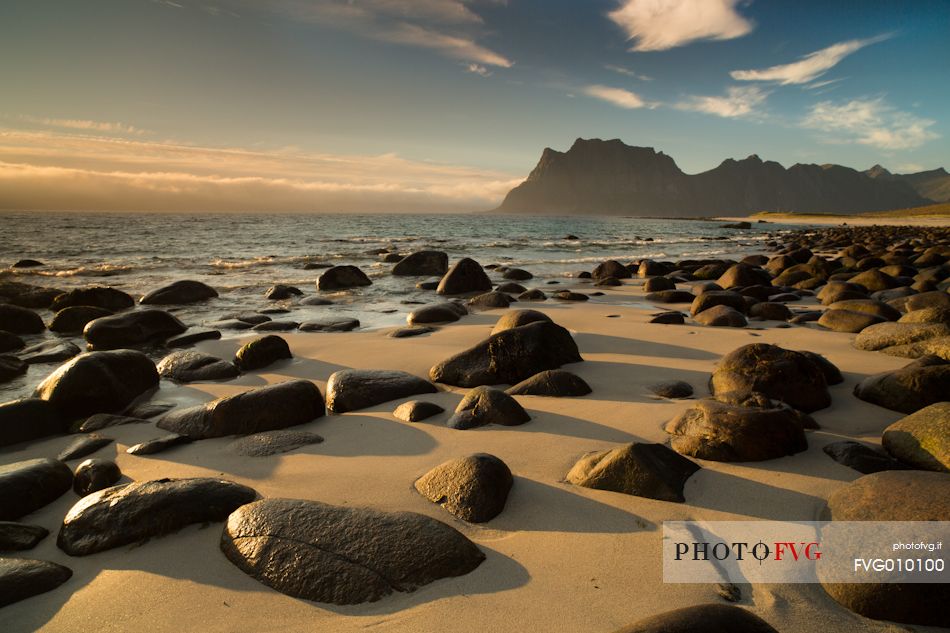 The Sunset on the beach of rounded rocks Utaklein