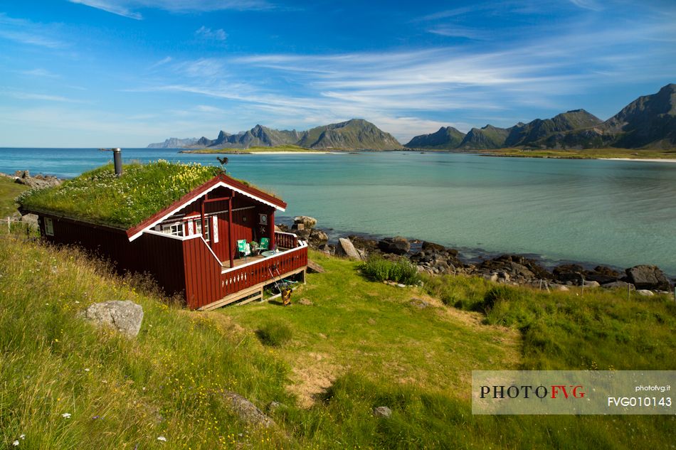 The mountains surrounding the white sand and crystal clear waters of the north coast of Gimsoya