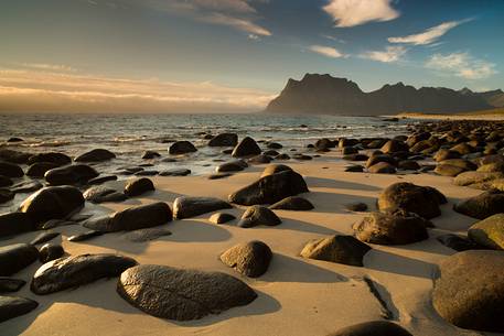 The Sunset on the beach of rounded rocks Utaklein