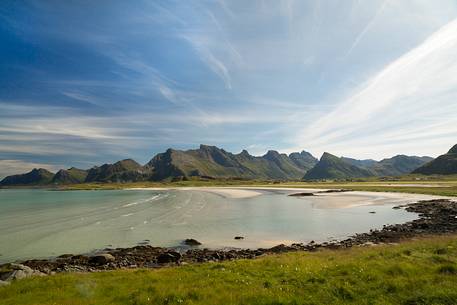 The mountains surrounding the white sand and crystal clear waters of the north coast of Gimsoya