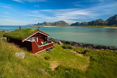 The mountains surrounding the white sand and crystal clear waters of the north coast of Gimsoya