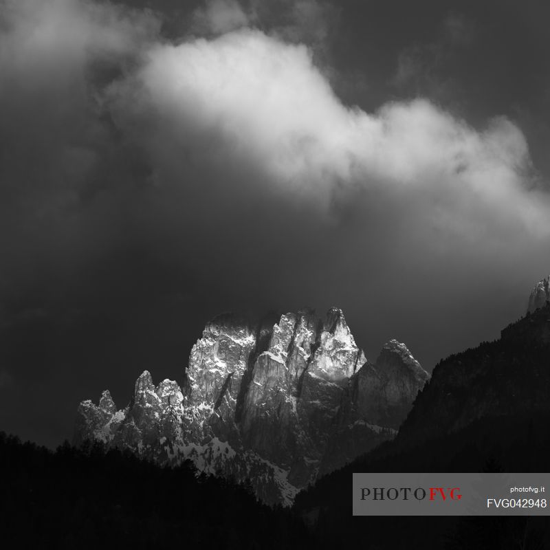 The Larsech mountain in the Catinaccio mountain range, lightened by a ray of light emerged from the thunder clouds, Fassa valley, dolomites, Trentino Alto Adige, Italy, Europe