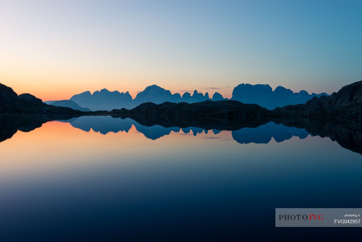 Brenta mountain range skyline at the dusk reflected on the Lago Nero of Cornisello, Nambrone valley, Madonna di Campiglio, Trentino Alto Adige, dolomites, Italy, Europe