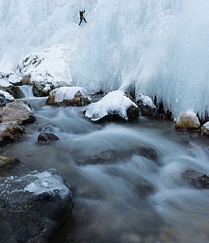 Climbing a frozen waterfall over the Pettorina river in Serrai di Sottoguda,. Marmolada mountain group, dolomites, Veneto, Italy, Europe