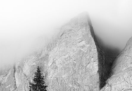 A detail of the Spigolo Abram of Piz Ciavazes mount in the Sella group wrapped in clouds, dolomites, Trentino Alto Adige, Italy, Europe