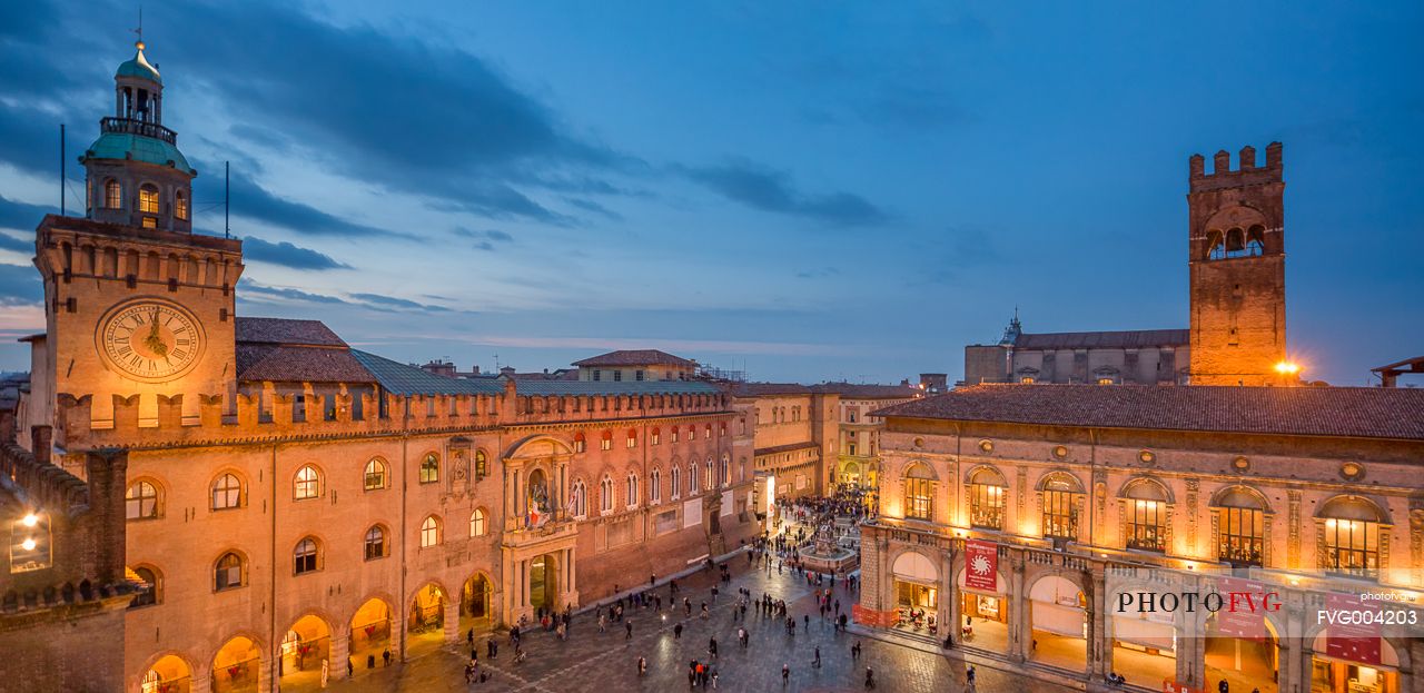 A view of Maggiore square, d'Accursio palace and Neptune fountain after the dusk, Bologna