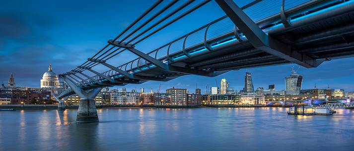 View of skyline underside the Millenium Bridge with San Paul and the City after the dusk from the south river of Thames