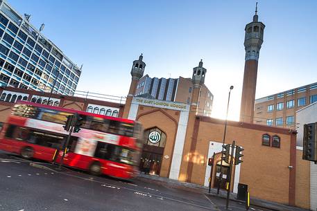 One famouse red double decker pass by hight speed in front of East Lodon Mosque
