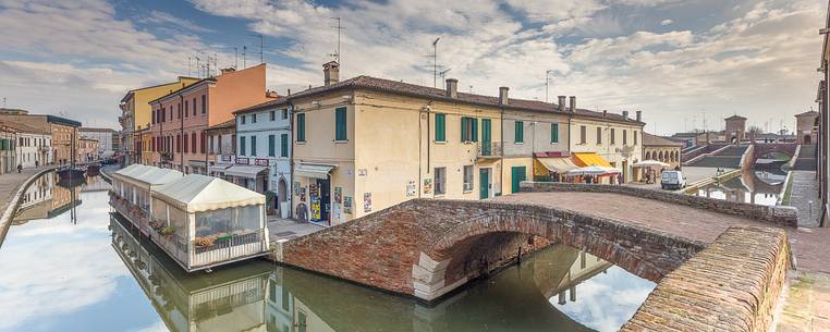 Morning view of small centre's rivers and Tre Ponti bridge