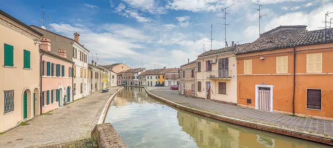 Morning view of a small river and tipical coloured houses Morning view of a small river and tipical coloured houses