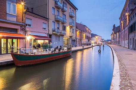 Evening view of a river with a ship and a tipical restaurant