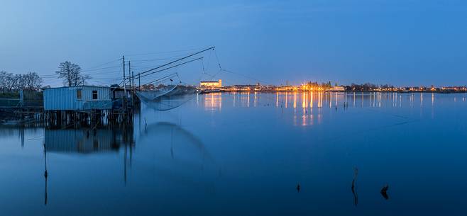 A house for fishing on the Comacchio's lagoon after the dusk A house for fishing on the Comacchio's lagoon after the dusk