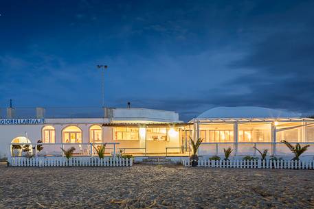 Baths on the beach in the gulf of Peschici after the dusk