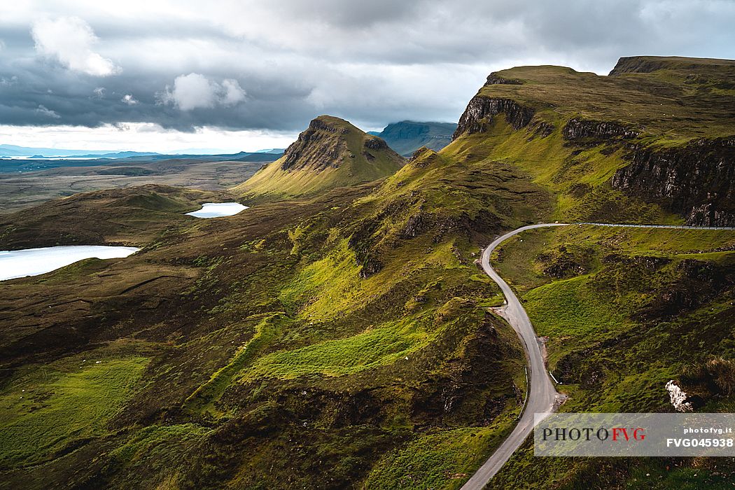 Tourist road crosses the lunar landscape of Quiraing, Trotternish Peninsula in the Isle of Skye, Highands, Scotland, United Kingdom, Europe