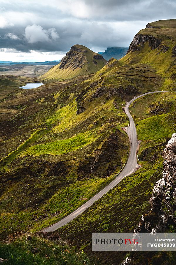 Tourist road crosses the lunar landscape of Quiraing, Trotternish Peninsula in the Isle of Skye, Highands, Scotland, United Kingdom, Europe