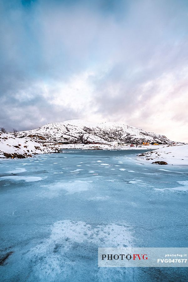 View of the frozen sea and the hill on the island of Sommary, Troms, Norway, Europe
