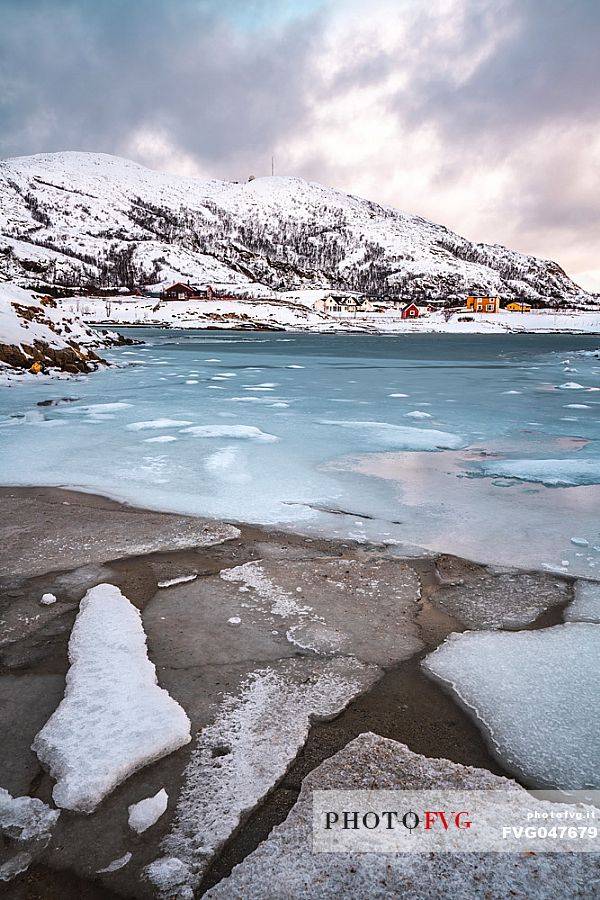 View of the frozen sea and the hill on the island of Sommary, Troms, Norway, Europe
