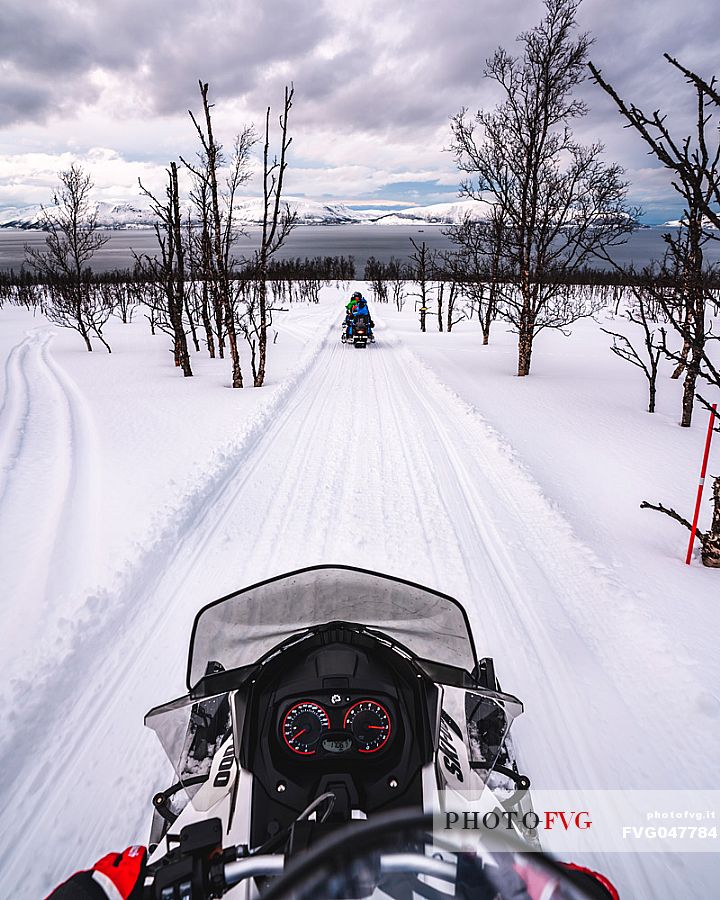 Snowmobile trip in the Lyngen Alps, Troms, Norway, Europe 
