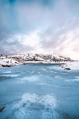 View of the frozen sea and the hill on the island of Sommary, Troms, Norway, Europe
