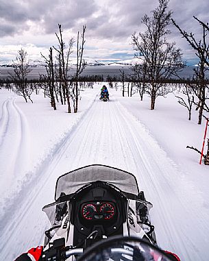 Snowmobile trip in the Lyngen Alps, Troms, Norway, Europe 
