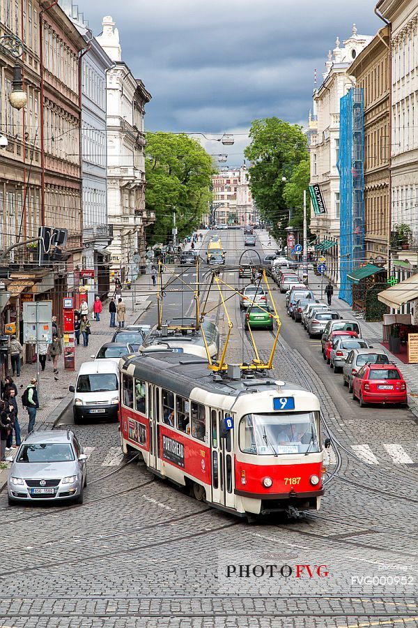 A red tram on a street of Prague new town