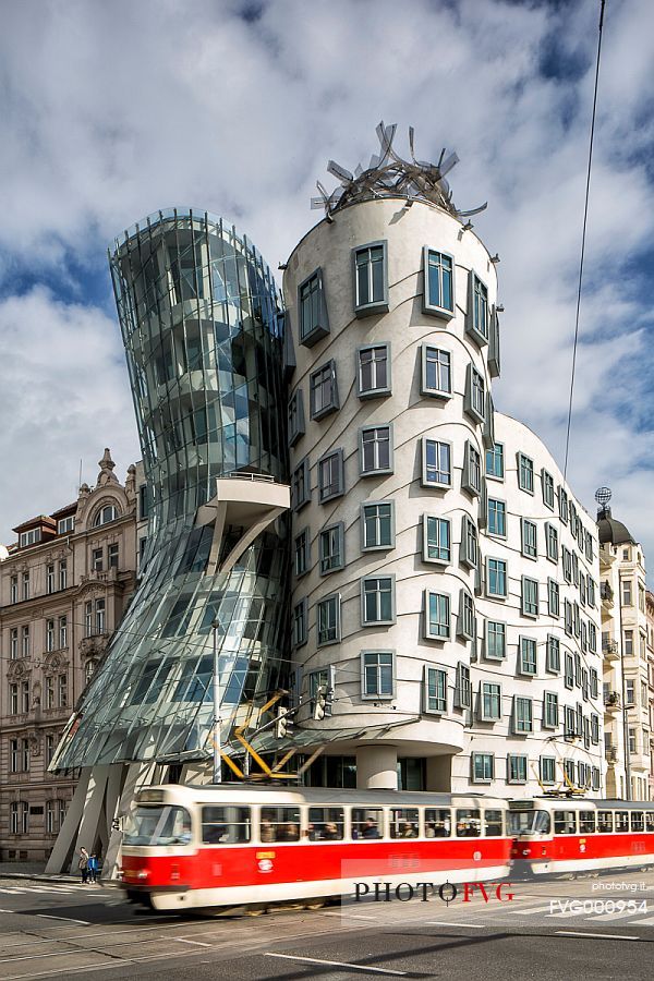 A tram crossing in front of the modern building called Tancici Dum, or Ginger and Fred, designed by Frank Gehry