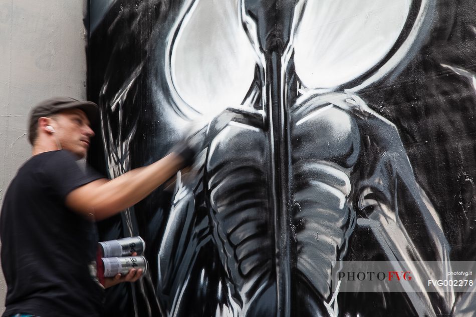 A street artist at work at The Rise of the non conformists street art exibition