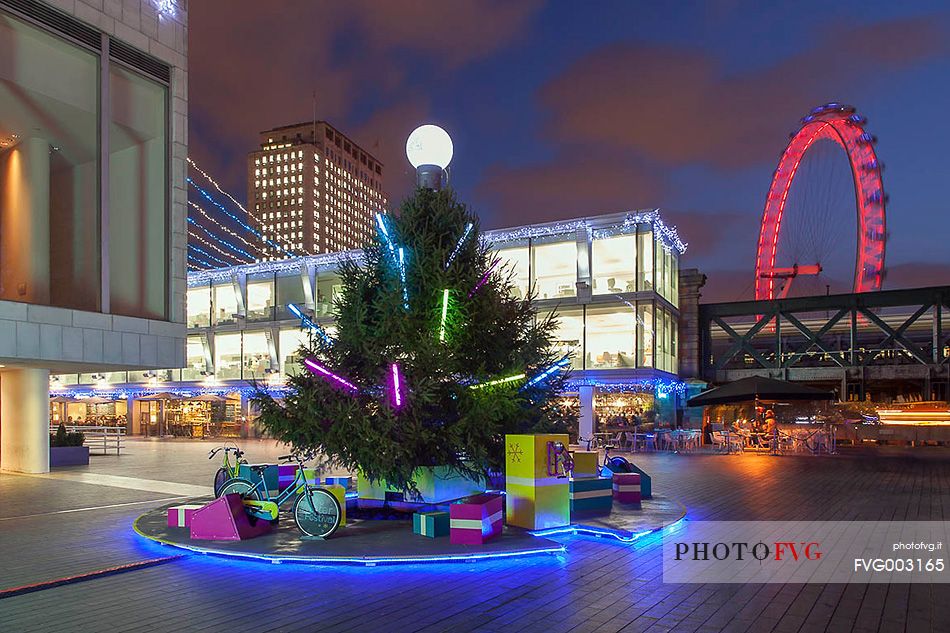 Christmas decorations in the South Bank center with London Eye in the background