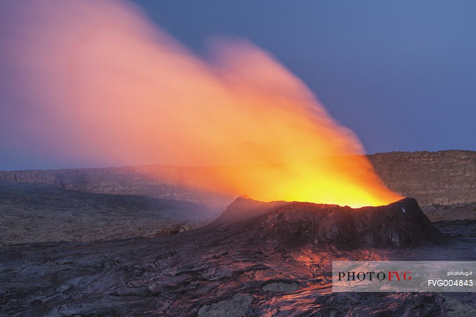 The crater of Erta Ale volcano in eruption, at dusk
