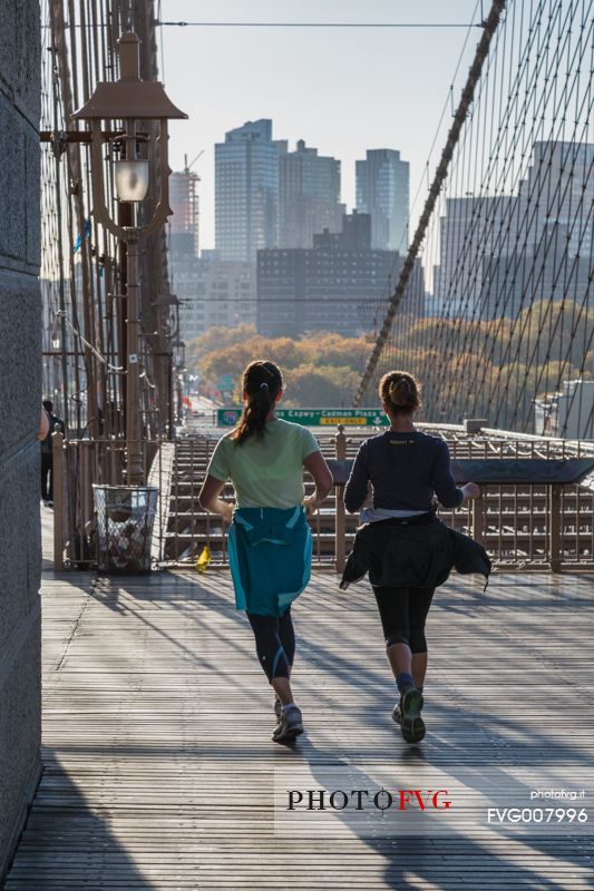 Young girls running on the Brooklyn Bridge