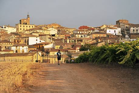 Pilgrim in the Way of St. James, Camino de Santiago to Compostela, arrival at Cirauqui in Navarre, Spain Pilgrim in the Way of St. James, Camino de Santiago to Compostela, arrival at Cirauqui in Navarre, Spain