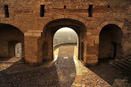 View of the lower city through the gate of Porta San Giacomo in the upper city of Bergamo, Lombardy, Italy