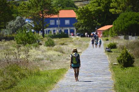 Young girl pilgrims arriving at Fisterra, Way of St. James, Finisterre, La Corua, Galicia, Spain
