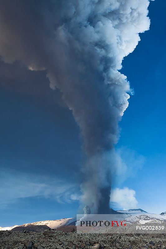 Etna,4th paroxysm of 2012,a huge cloud of ash rises into the sky while below a pyroclastic cloud invades the snowfields