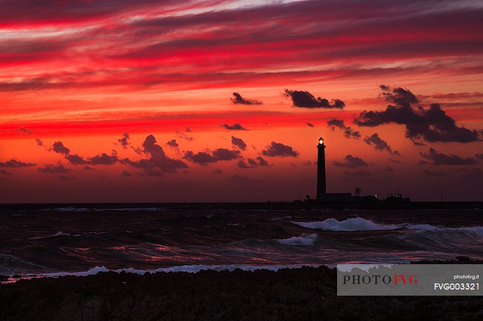 A fiery sunset in Favignana, in the background the lighthouse of Punta Sottile.