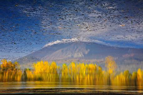Reflection of Mount Etna on Gurrida lake in the fall 