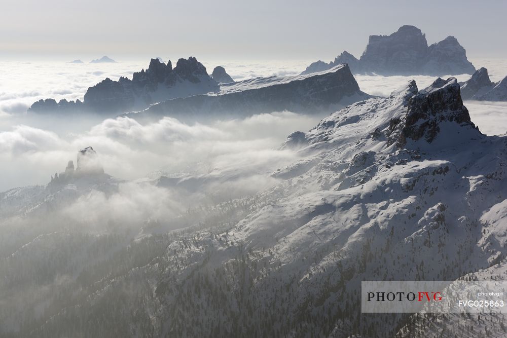 Sunrise from the top of the mountain Lagazuoi towards the Dolomites of Cortina and Zoldana valley.
Cold and windy winter morning with the phenomenon of thermal inversion, dolomites, Italy