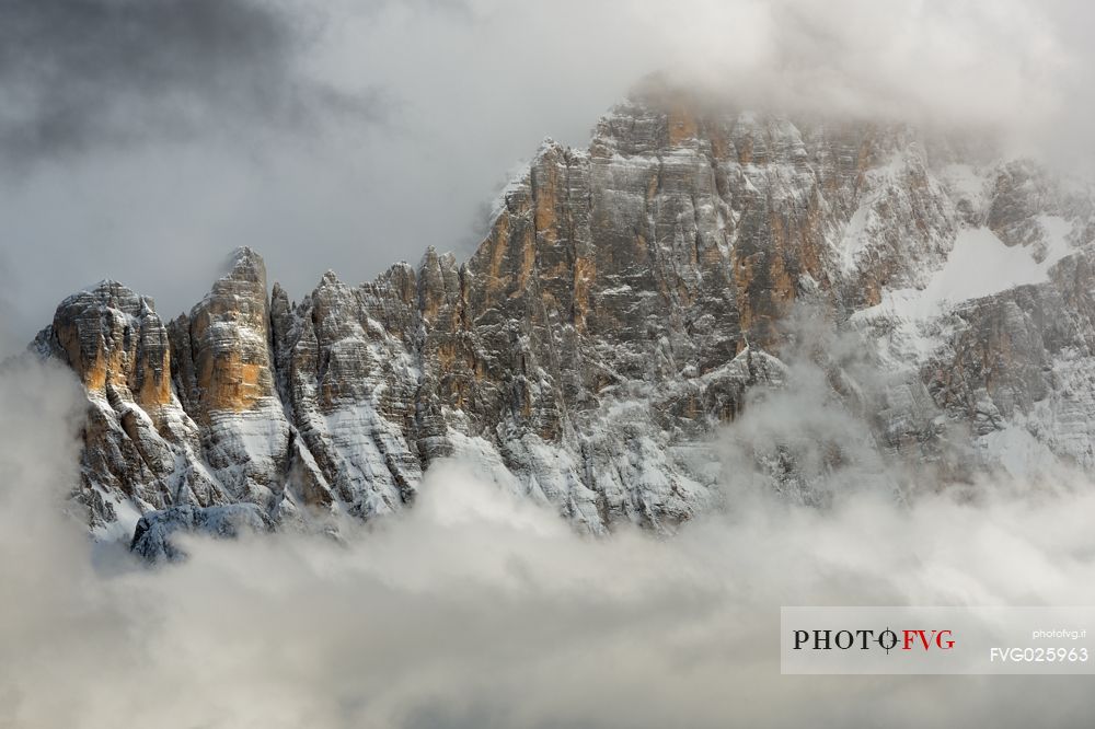 The north-west wall of the Civetta mount wrapped in stormy cloud, dolomites, Italy