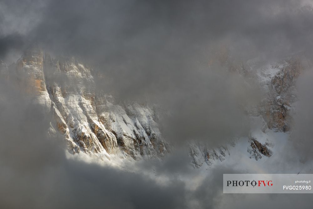 The north-west wall of the Civetta mount wrapped in stormy cloud, dolomites, Italy